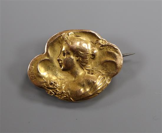 A French Art Nouveau repouse yellow metal brooch, decorated with the bust of a lady and bearing the signature Diolot, 30mm.